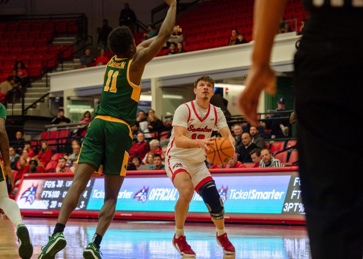 Point guard Dean Noll pump fakes a shot against Norfolk State on Wednesday, Dec. 13. Noll led the Stony Brook mens basketball team with four steals against Michigan State on Friday. BRITTNEY DIETZ/THE STATESMAN