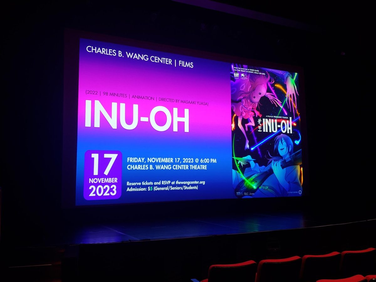 The film poster for the Japanese animated film “Inu-Oh displayed on the screen of the Charles B. Wang Center Theatre. As part of its fall showings, the film screening was held on Nov 17. CHRISTINA MARIE MARIANI/THE STATESMAN