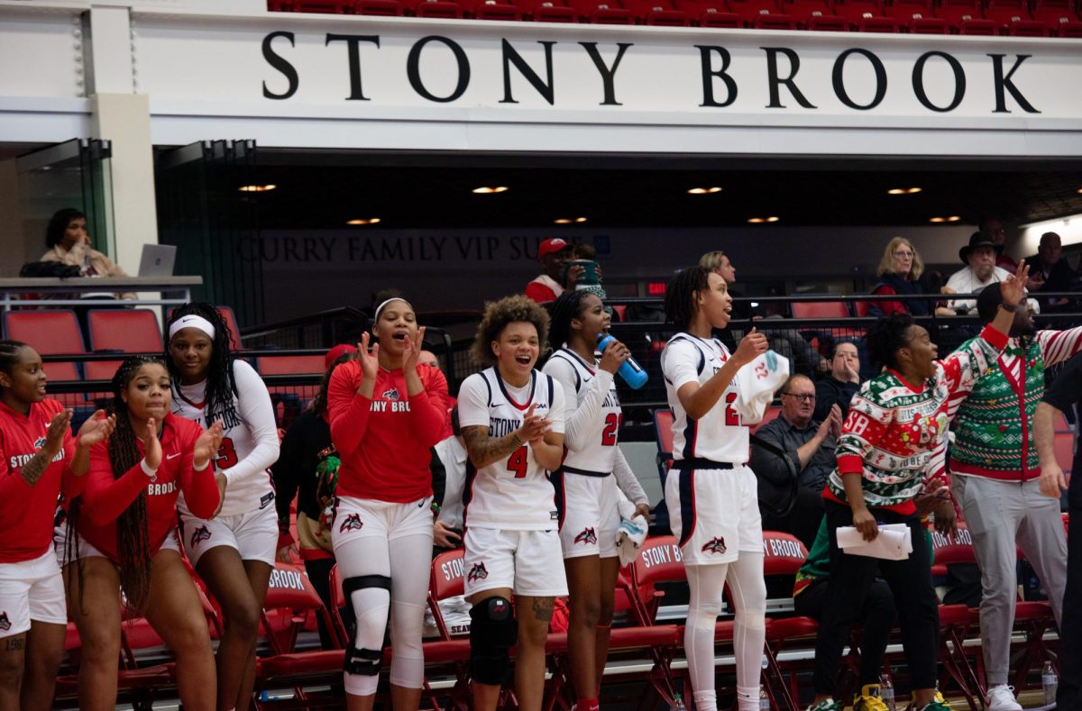 The Stony Brook womens basketball team celebrates a made shot against Longwood on Dec. 11. The Seawolves will host an injury-plagued opponent on Sunday. BRITTNEY DIETZ/THE STATESMAN