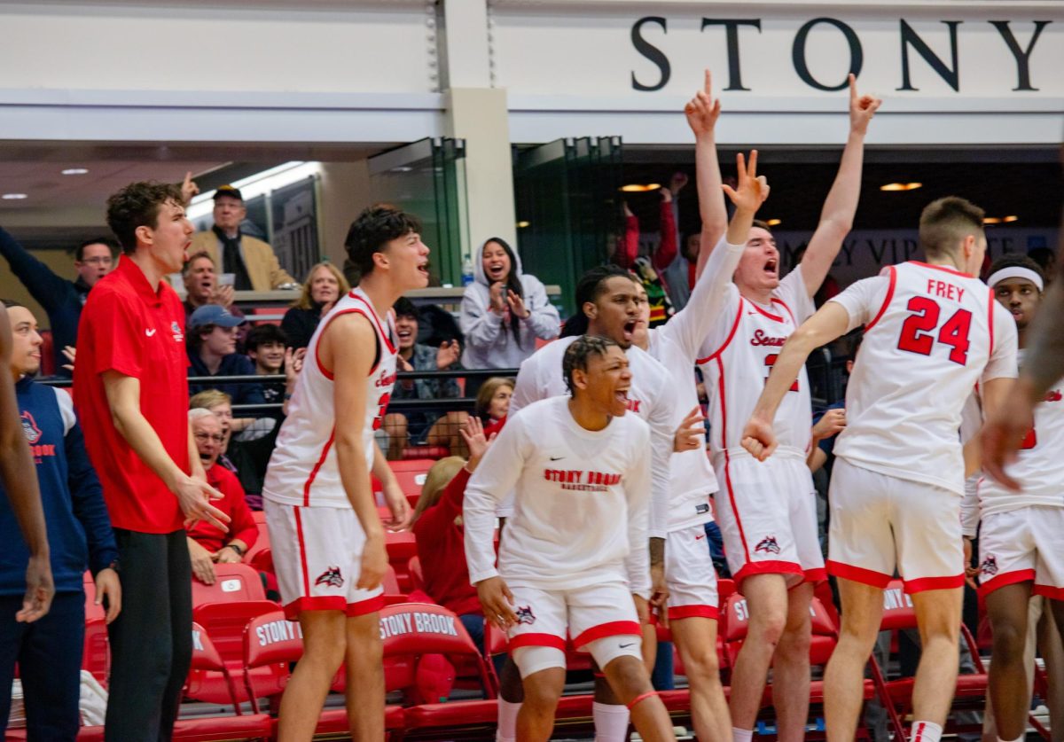 Several Stony Brook mens basketball players celebrate a big shot against Norfolk State on Dec. 13. The Seawolves will host the College of Charleston for their second conference game of the year tomorrow. BRITTNEY DIETZ/THE STATESMAN