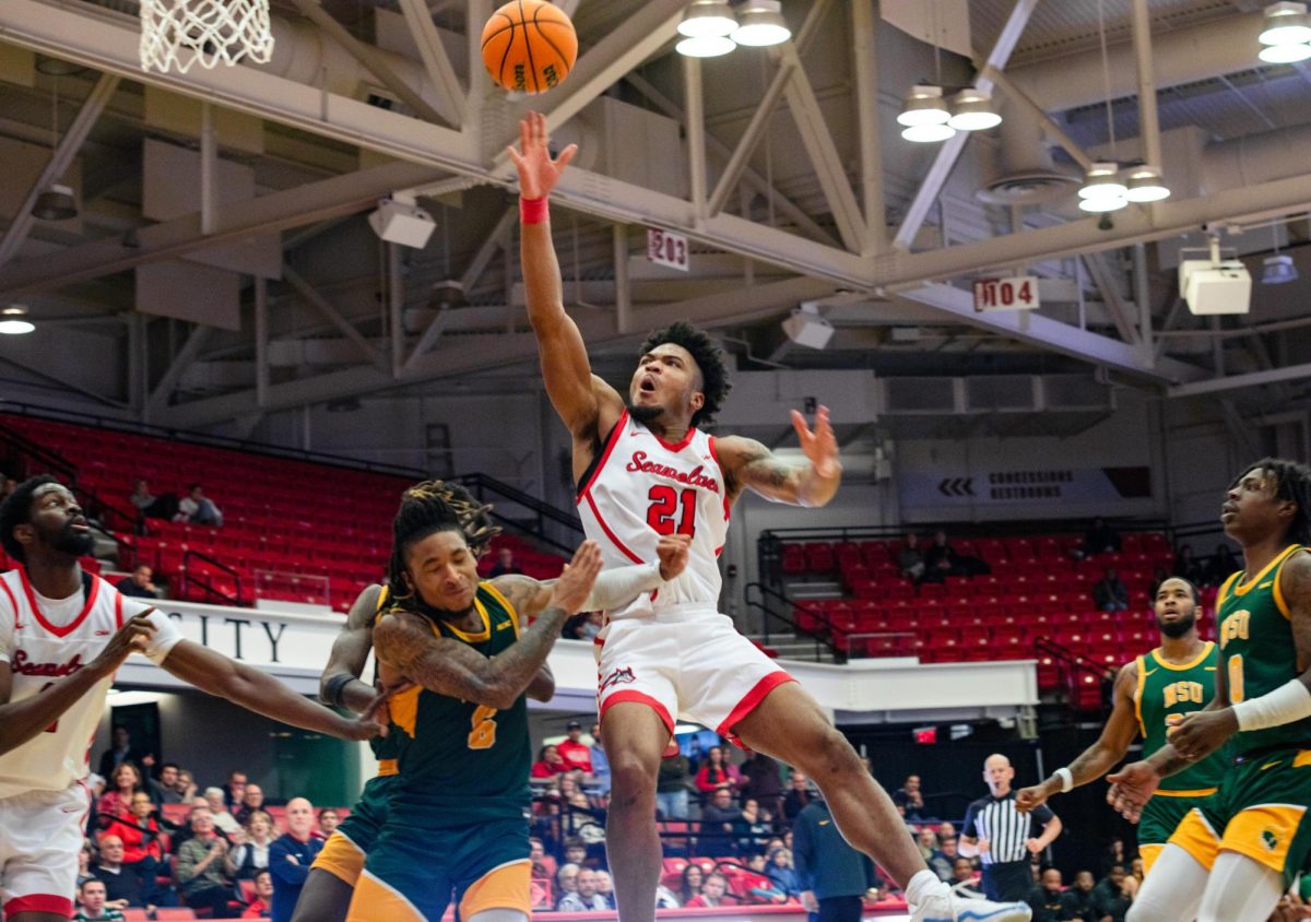 Power Andre Snoddy tosses up a layup against Norfolk State while center Chris Maidoh sets up for a rebound on Wednesday, Dec. 13. Snoddy and Maidohs presence in the paint will be instrumental in tomorrows game at Northeastern. BRITTNEY DIETZ/THE STATESMAN
