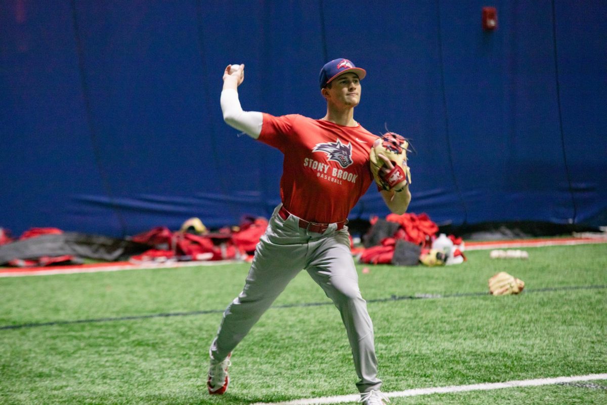 Second baseman Evan Fox plays catch in practice on Wednesday, Jan. 24. Fox is entering the last year of his illustrious career with the Stony Brook baseball team. BRITTNEY DIETZ/THE STATESMAN