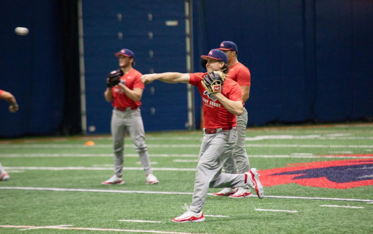 Infielder Evan Goforth (foreground) makes a relay throw in practice on Wednesday, Jan. 24. Goforth is a transfer from Indiana who is likely to be a starter on the Stony Brook baseball team this year. BRITTNEY DIETZ/THE STATESMAN