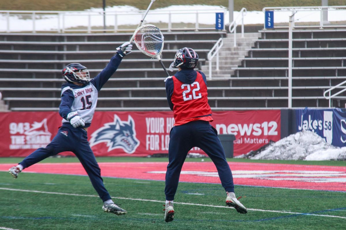 Attackman Nick Dupuis (left) tries to shoot over goalkeeper Jamison MacLachlan (right) on Wednesday, Jan. 24. The two players were instrumental in the Stony Brook mens lacrosse teams win on Sunday. BRITTNEY DIETZ/THE STATESMAN