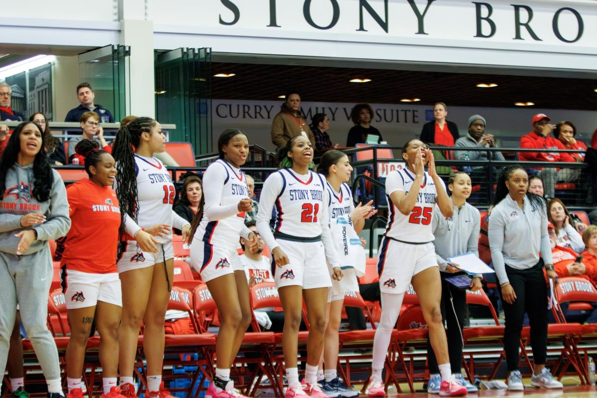 Several Stony Brook womens basketball players celebrate from the sideline against Hofstra on Friday, Feb. 16. The Seawolves earned a win by forfeit for tomorrows game versus Northeastern. STANLEY ZHENG/THE STATESMAN