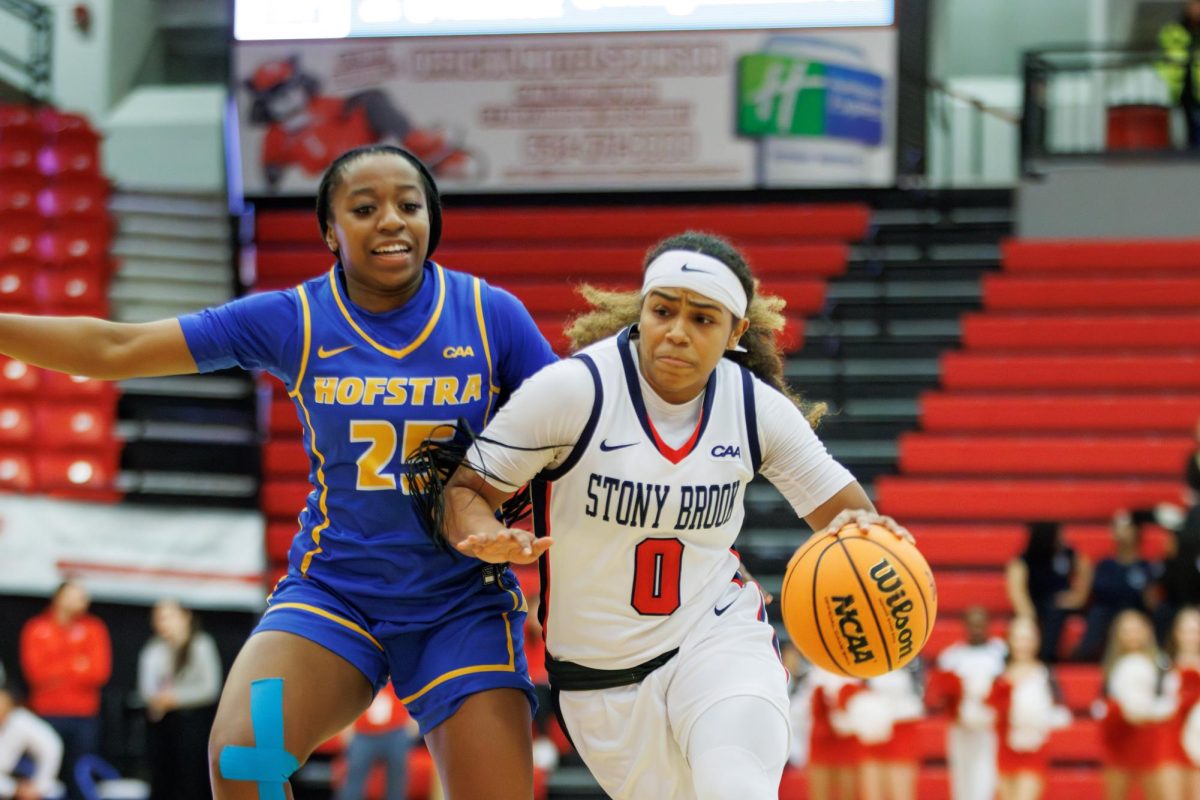 Point guard Gigi Gonzalez penetrates through Hofstra point guard Micaela Carter on Friday, Feb. 16. Gonzalez led the Stony Brook womens basketball team to a victory with 24 points and six assists against the Pride. STANLEY ZHENG/THE STATESMAN