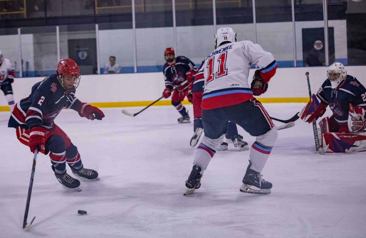 Left defenseman Joey Trazzera (left) takes the puck away from Liberty left winger D.J. Schwenke on Jan. 27. Trazzera and his fellow defensemen will be tasked with locking down Drexels hot offense tomorrow night. MACKENZIE YADDAW/THE STATESMAN
