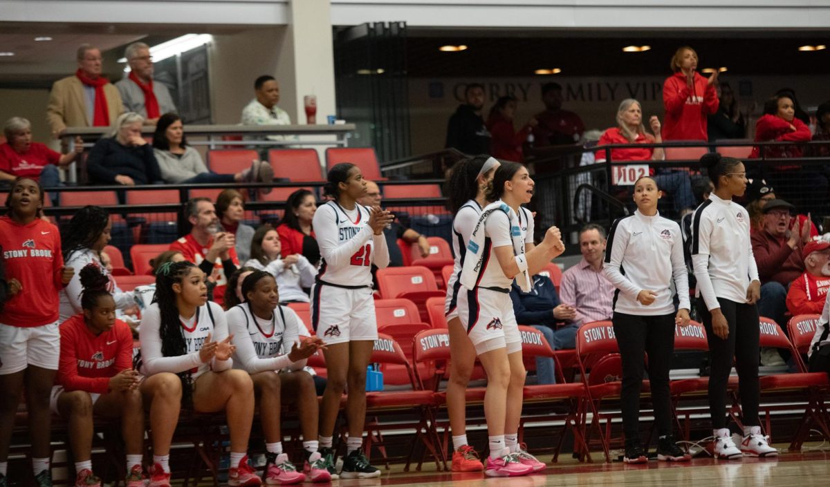 Several Stony Brook womens basketball players cheer on their teammates from the sideline during a game versus Towson on Friday, Feb. 9. The Seawolves will host Hofstra tomorrow night. MACKENZIE YADDAW/THE STATESMAN