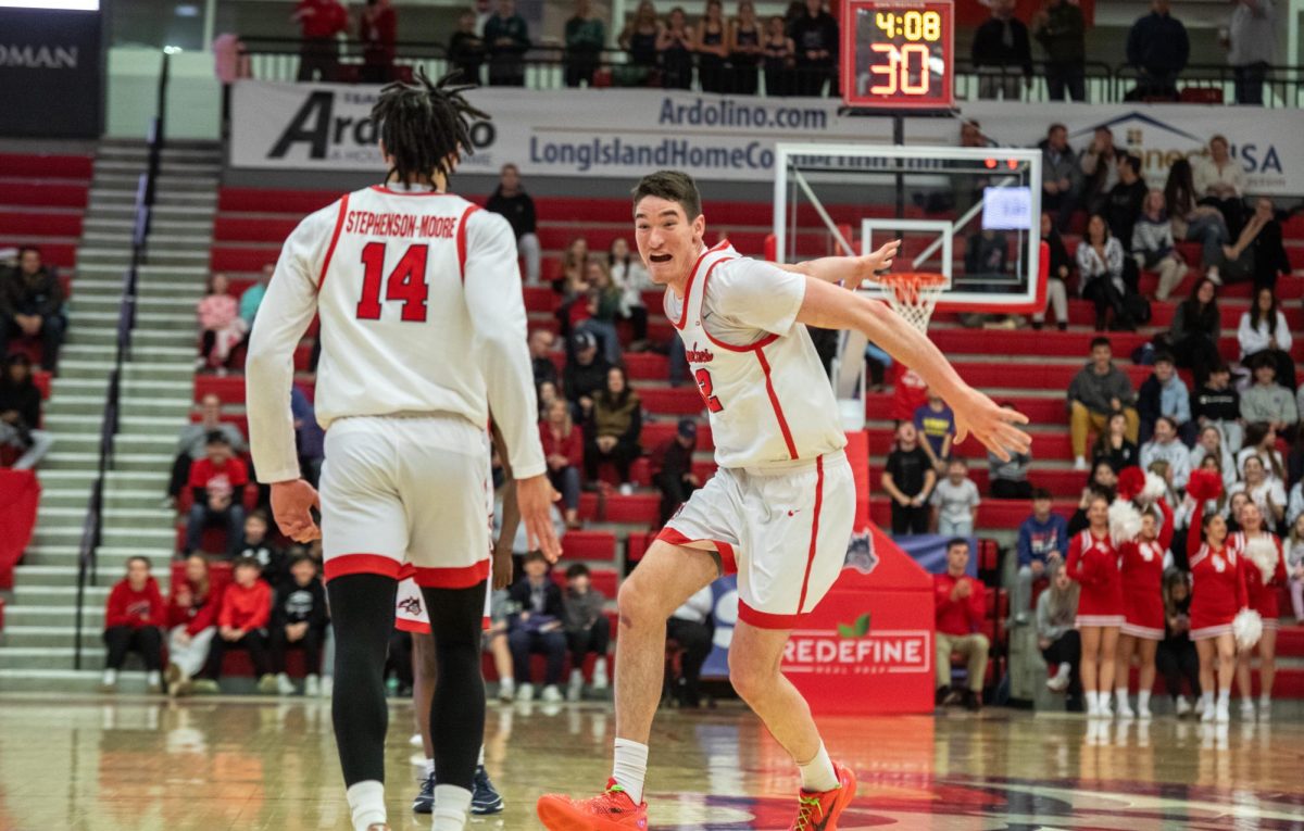 Center Keenan Fitzmorris (right) emphatically celebrates during a stoppage in play with small forward Tyler Stephenson-Moore on Thursday, Feb. 15. The two players led the Stony Brook mens basketball team to a win versus Hampton. ANGELINA LIVIGNI/THE STATESMAN