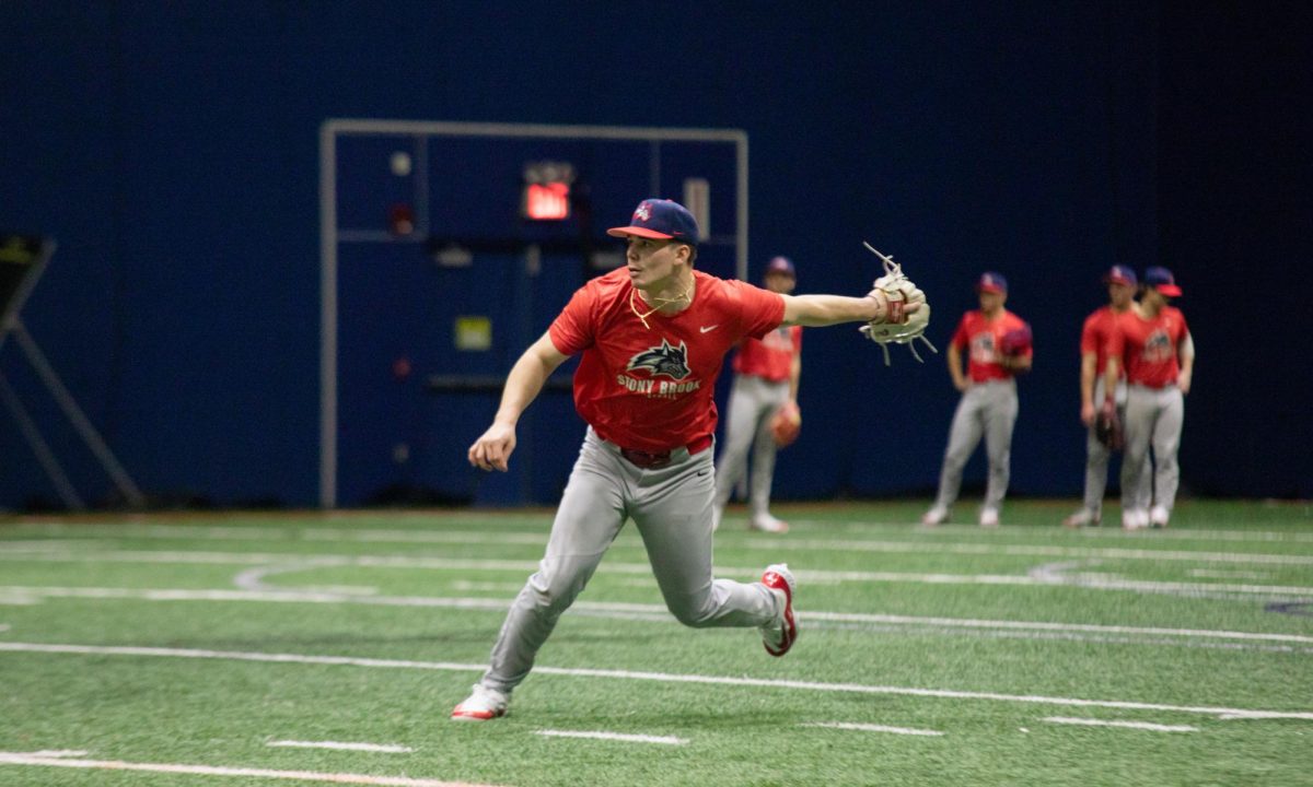 Left fielder Matt Brown-Eiring throws from the outfield in practice on Jan. 24. Brown-Eiring went 7-for-16 with nine runs batted in the Stony Brook baseball teams season-opening series. BRITTNEY DIETZ/THE STATESMAN