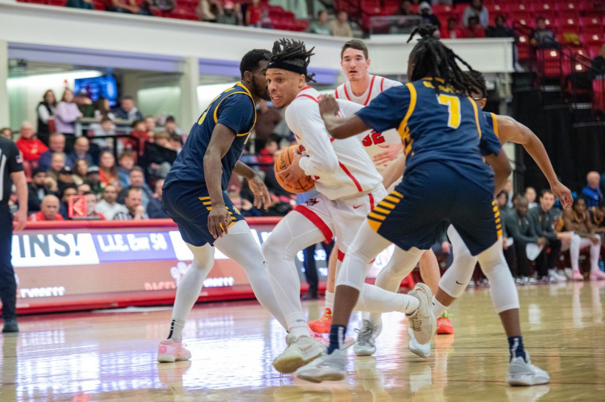 Small forward Tyler Stephenson-Moore drives the lane through two North Carolina A&T defenders on Thursday, Feb. 22. Stephenson-Moore scored a career-high 28 points in the Stony Brook mens basketball teams win. MACKENZIE YADDAW/THE STATESMAN