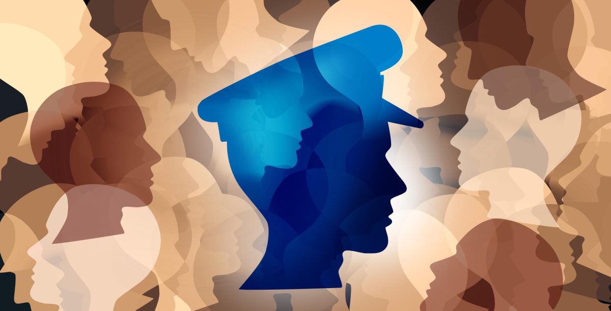 A stock image displaying a police officer amongst a background of regular citizens. 
FRESHIDEA - STOCK.ADOBE.COM