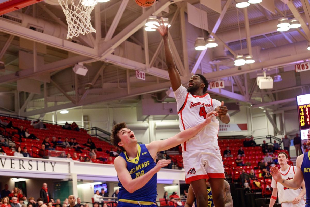 Center Chris Maidoh lays one up through contact against Delaware on Saturday, March 2. Maidoh played the best game of his career in the Stony Brook mens basketball teams upset win over Drexel on Sunday. ANGELINA LIVIGNI/THE STATESMAN