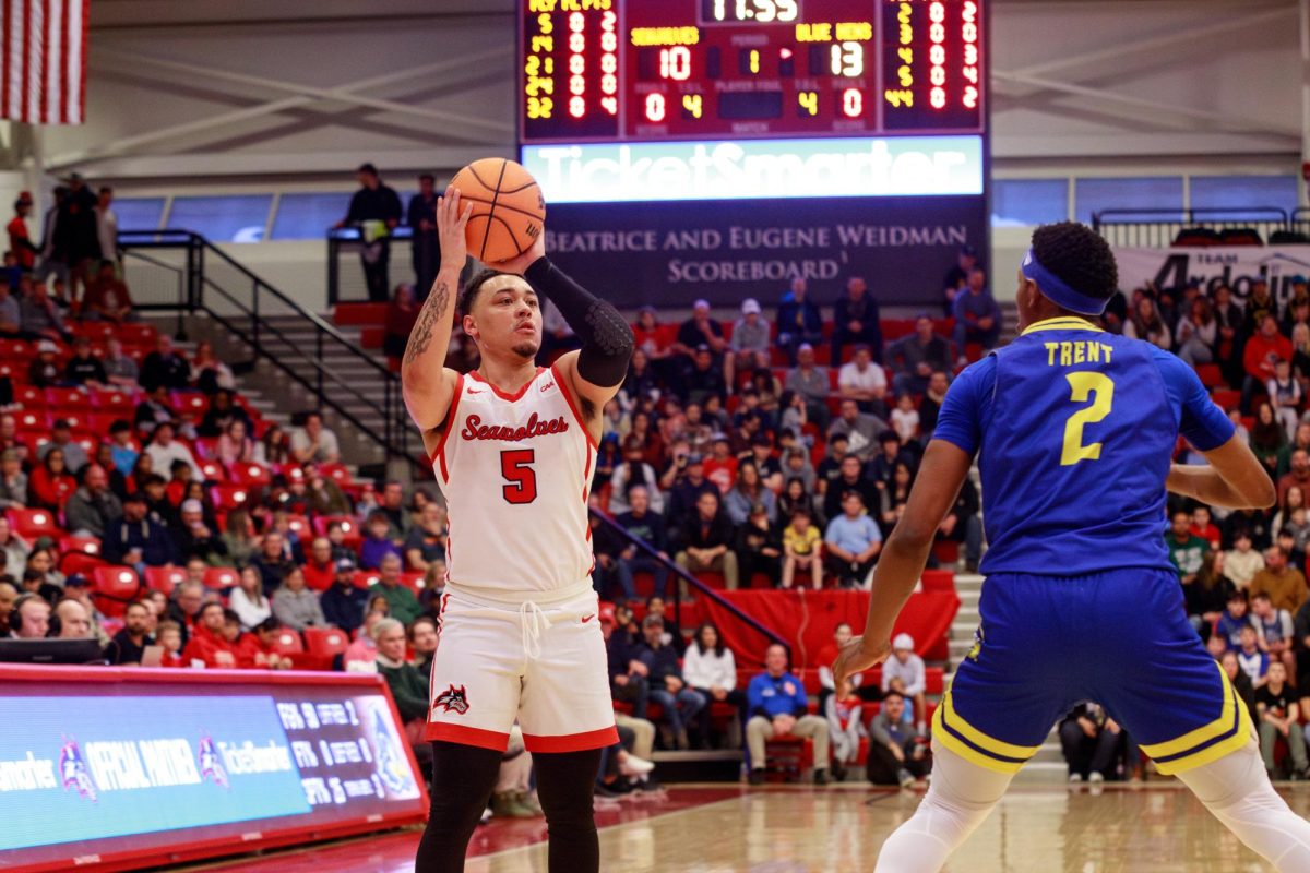 Point guard Aaron Clarke shoots over Delaware point guard Jalun Trent on Saturday, March 3. Clarke led the Stony Brook mens basketball team with 19 points in a blowout win. ANGELINA LIVIGNI/THE STATESMAN