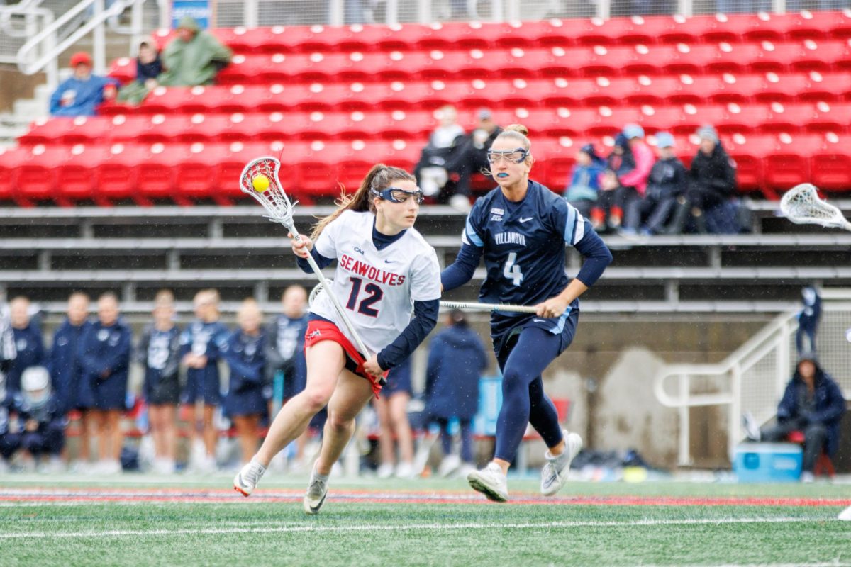 Midfielder Ellie Masera dodges a Villanova defender on Saturday, March 3. Masera broke the Stony Brook womens lacrosse teams program record for most draw controls in a game. STANLEY ZHENG/THE STATESMAN