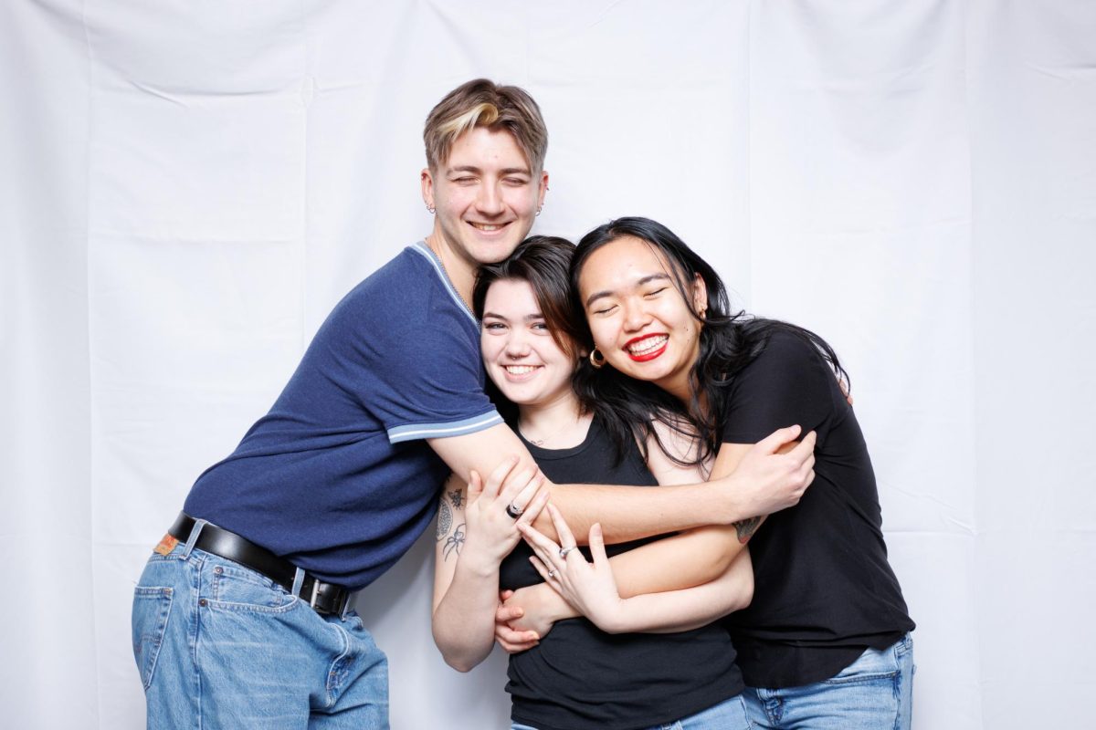 Kevin Dardzinski, Mackenzie Yaddaw and Natalia Wong (from left to right), embracing each other at the Sex and Relationships photoshoot. STANLEY ZHENG/THE STATESMAN