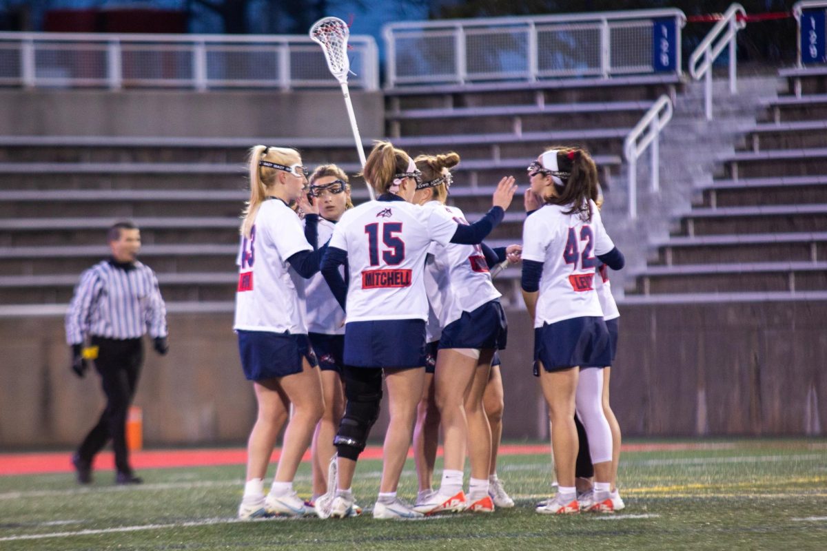 The Stony Brook womens lacrosse teams top players gather to celebrate a goal against Elon on Friday, March 22. The Seawolves will host Campbell tomorrow afternoon. ANGELINA LIVIGNI/THE STATESMAN