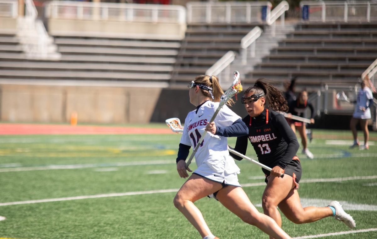 Attacker Kailyn Hart dodges a Campbell defender on Sunday, March 24. Hart led the Stony Brook womens lacrosse team with five goals in the victory. CHRISTOPHER SCHULZ/THE STATESMAN