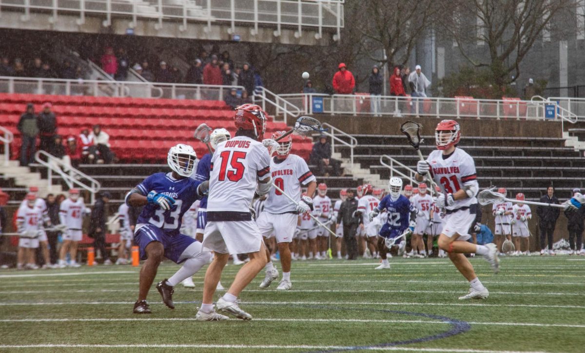 Attackman Nick Dupuis (15) passes to the ball to defensive midfielder Ben Morschauser (31) against Hampton on Saturday, March 2. Dupuis had five assists and nine total points against Providence on Saturday. BRITTNEY DIETZ/THE STATESMAN