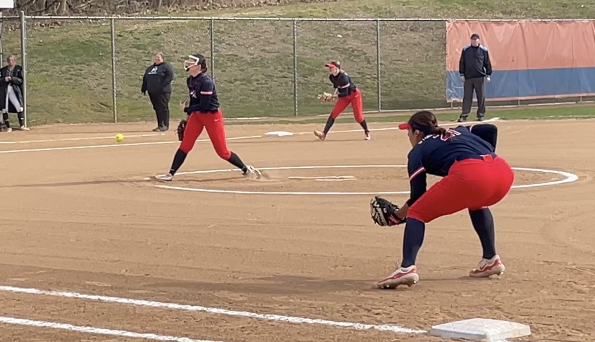Starting pitcher Gabrielle Maday (center) fires a pitch against Manhattan on Wednesday, March 20. Maday pitched a five-inning shutout to help the Stony Brook softball team sweep a doubleheader. MIKE ANDERSON/THE STATESMAN
