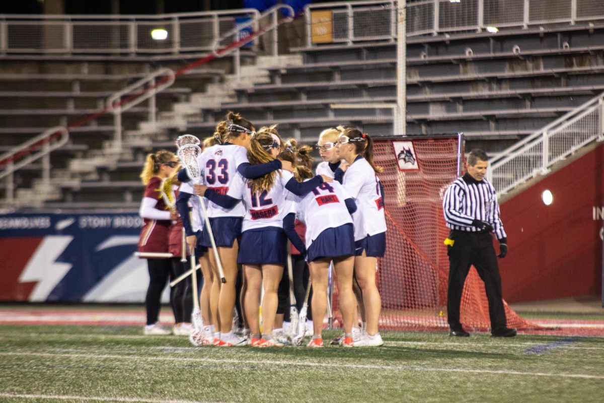 Players from the Stony Brook women’s lacrosse team huddle up to celebrate a goal against Elon on Friday, March 22. The Seawolves will square off against Monmouth in New Jersey on Friday. ANGELINA LIVIGNI/THE STATESMAN 