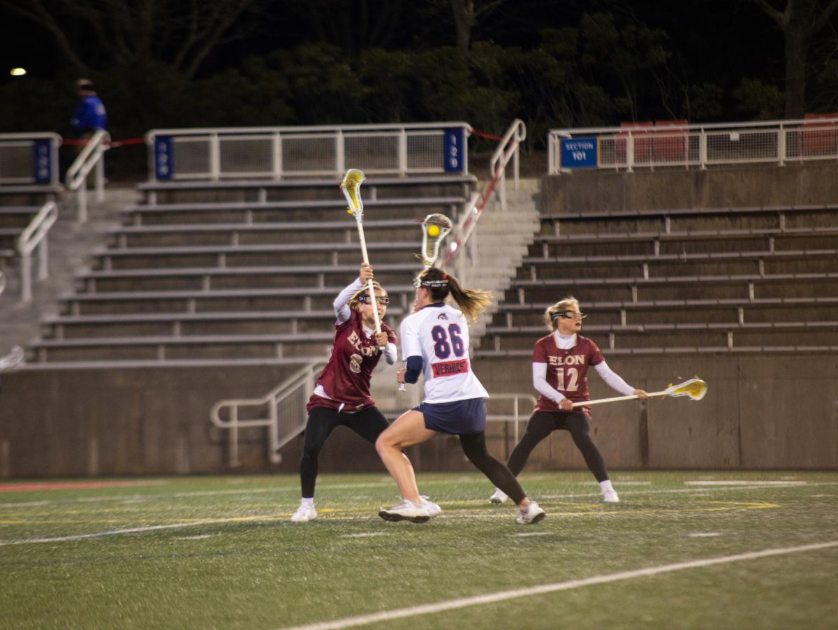 Midfielder Charlotte Verhulst maneuvers around a pair of Elon players on Friday, March 22. Verhulst netted a hat trick and tallied an assist in Fridays victory over Monmouth. ANGELINA LIVIGNI/THE STATESMAN