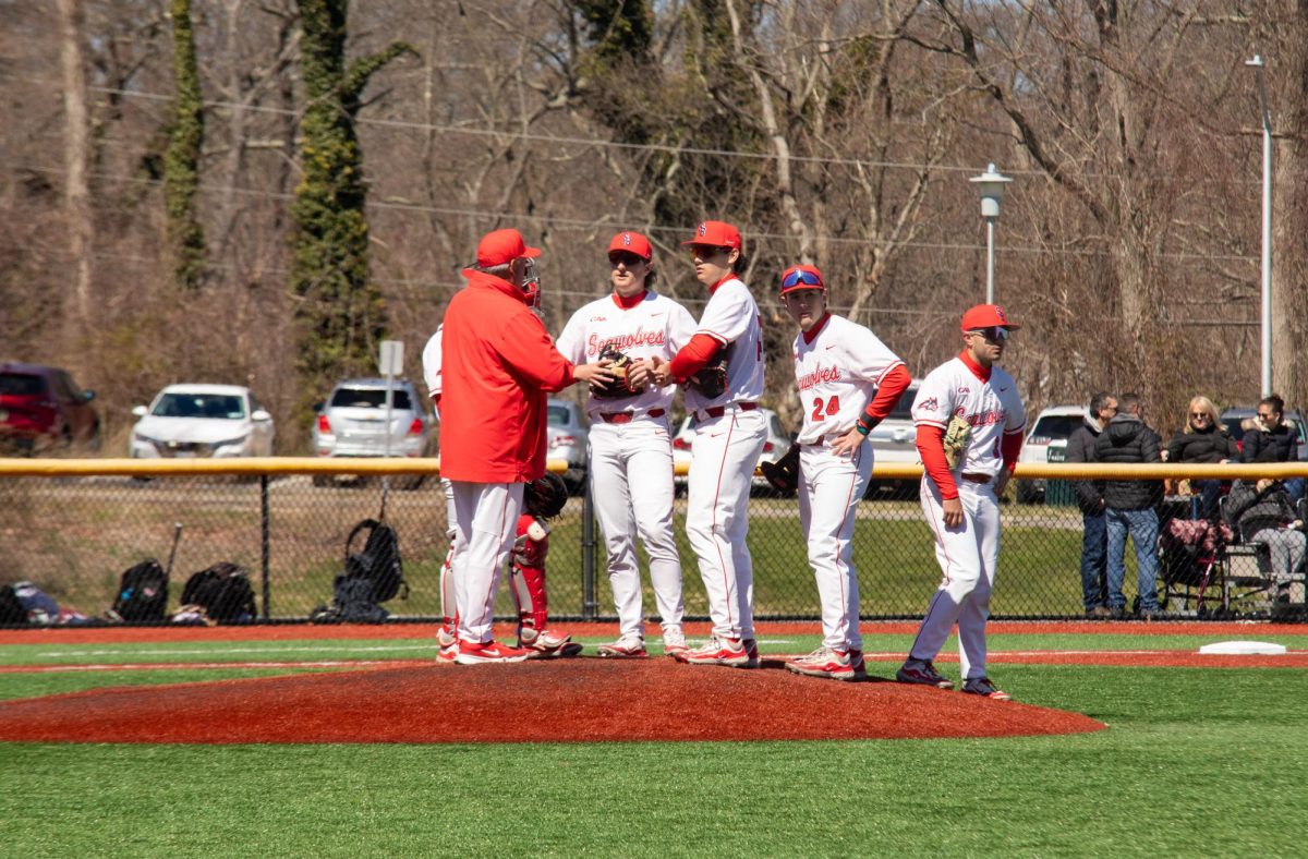 Head coach Matt Senk (left) talks to his infield during a pitching change against Charleston on Saturday, March 30. Senk and the Stony Brook baseball team will host Elon this weekend for a three-game series. MACKENZIE YADDAW/THE STATESMAN