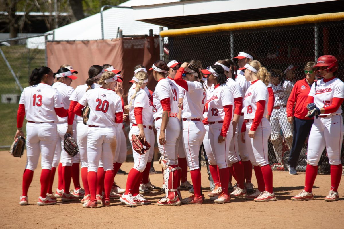 Players from the Stony Brook softball team huddle together in between innings against Elon on Friday, April 26. The Seawolves will square off against Hofstra on Wednesday in the first round of the 2024 CAA softball tournament. ANGELINA LIVIGNI/THE STATESMAN